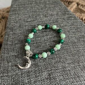 Glass multi toned green beaded flower crescent moon pendant stretch bracelet